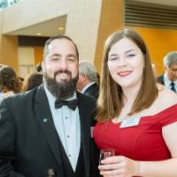 Guests posing, holding drinks in the Grand Gallery